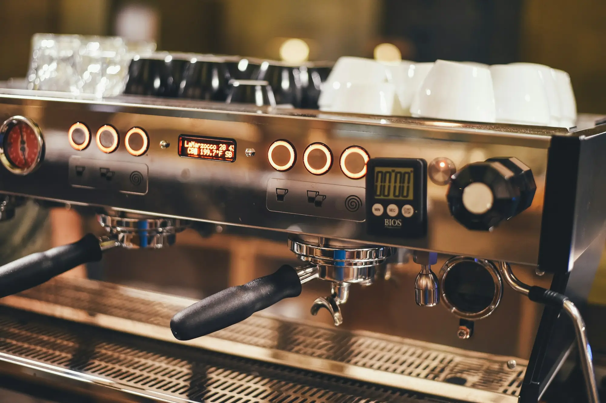 Close-up of a commercial espresso machine in a busy café