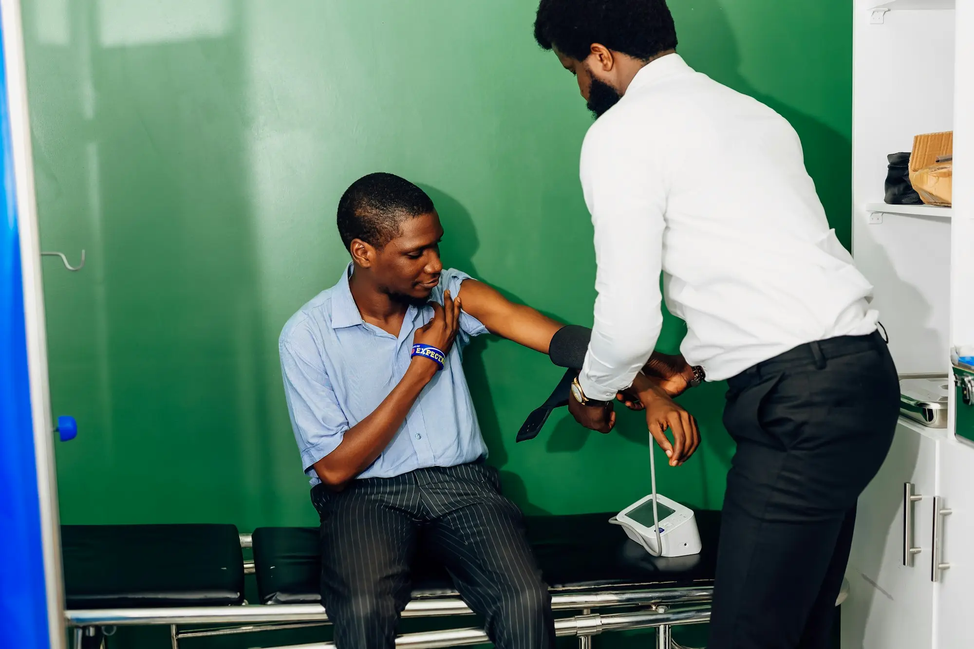 Health practitioner assessing a patient in a clinic room